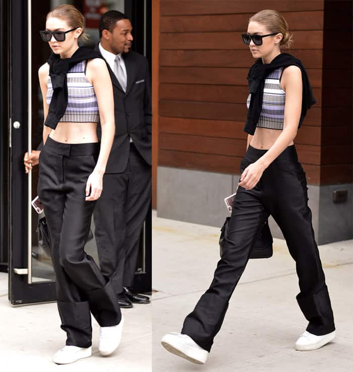 Gigi Hadid effortlessly pulls off a casual chic look, wearing rolled-up black pants with an Elizabeth & James striped crop top and Ash platform sneakers in New York