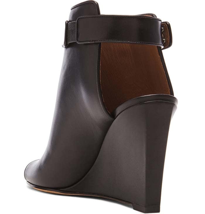 Givenchy calfskin ankle bootie featuring a 3.5" covered wedge and 6" boot height