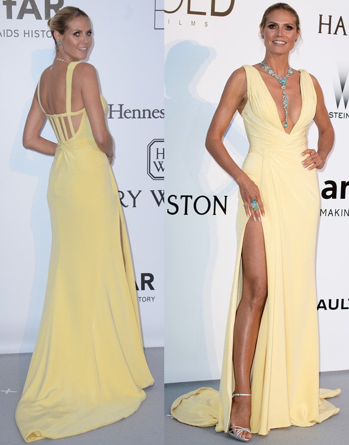 Heidi Klum shows off her legs and chest in a revealing yellow Versace gown