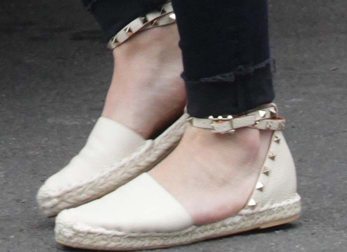 Hilary Duff steps out in chic Valentino 'Rockstud' espadrilles, featuring the brand's iconic gold studs and a comfortable jute sole for a perfect blend of casual and luxury