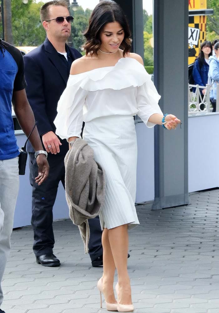 Jenna Dewan-Tatum wears a white off-the-shoulder top and pleated leather skirt from L'Agence for an appearance on Extra TV