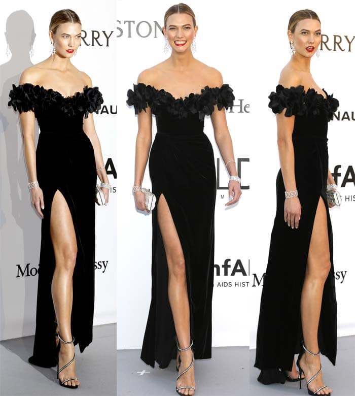 Karlie Kloss shows off her model legs in a black floor-length Marchesa gown