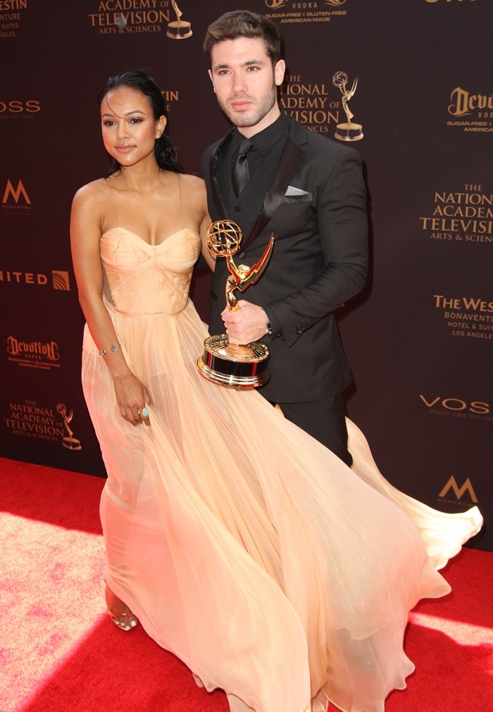Karrueche Tran poses with Kristos Andrews and the Emmy they received for "The Bay"