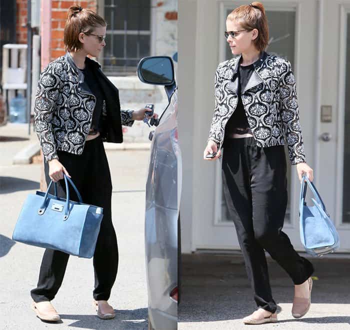 Kate Mara steps out in West Hollywood on May 26, 2016, showcasing a chic look with a printed lace jacket, black sweatpants, a cropped top, stylish loafers, and a large blue tote bag