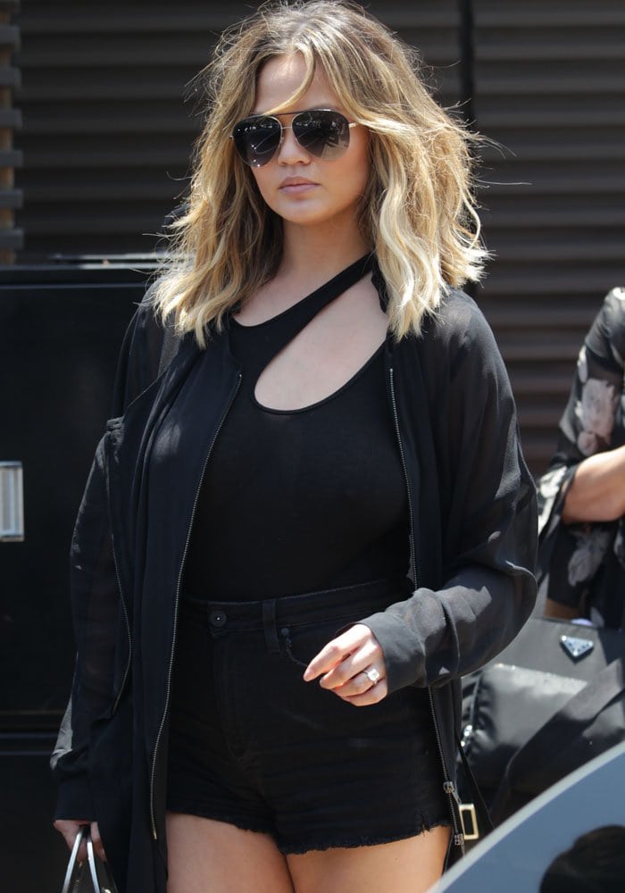 New mom Chrissy Teigen wears an all-black ensemble for her lunch date with the Kardashian-West couple