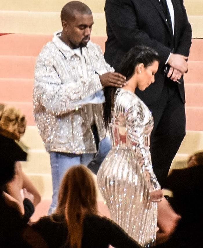 Kanye West fixes wife Kim Kardashian's hair before stepping on the red carpet for photos