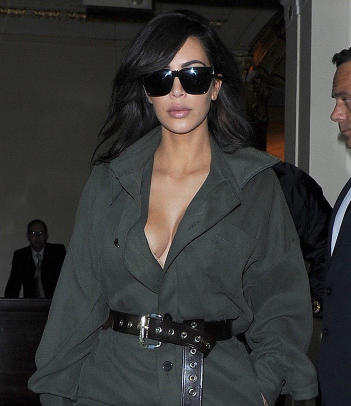 Kim Kardashian in a khaki jumpsuit wears her hair down as she leaves the Dorchester Hotel in London