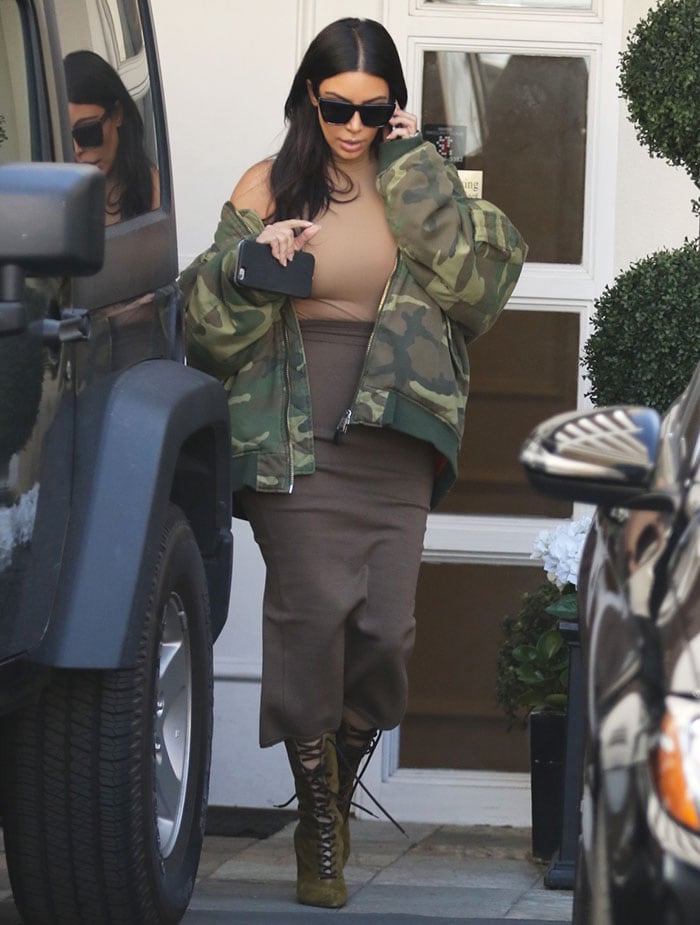 Kim Kardashian wearing Kanye's camo-printed bomber jacket from the Raf Simons AW01 collection