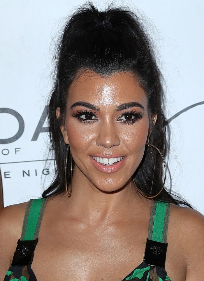 Kourtney Kardashian pulled her raven locks into a high ponytail and accentuated her stunning facial features with subtle smoky eye-makeup, mascara and nude lipstick