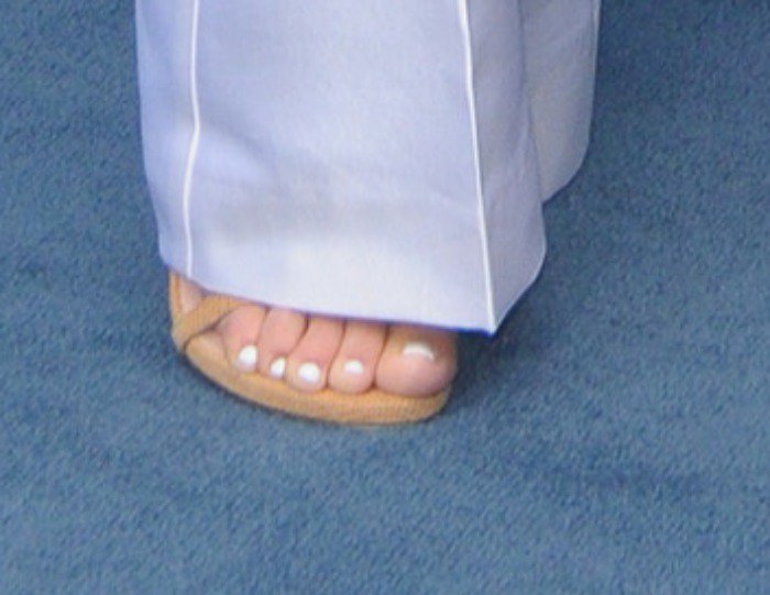 Kourtney Kardashian showing off her feet in tan sandals