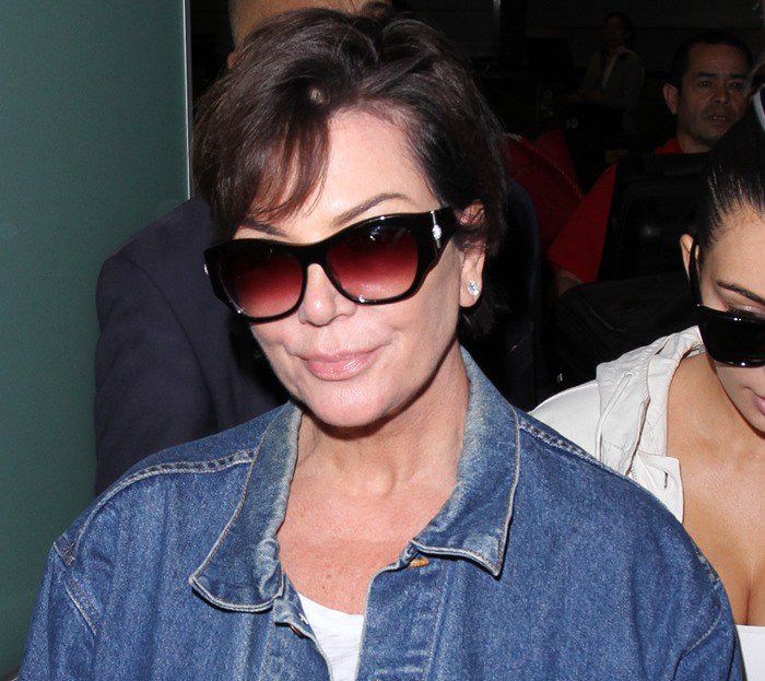 Kris Jenner wears dark sunglasses as she arrives from France at LAX