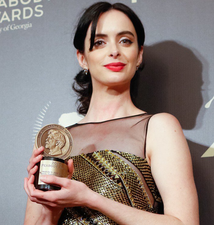Krysten Ritter pulls her hair back into a ponytail for the 2016 Peabody Awards