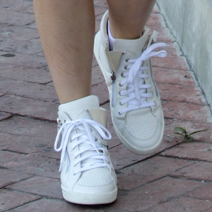 Kylie Jenner's feet in white Chanel zip-top sneakers