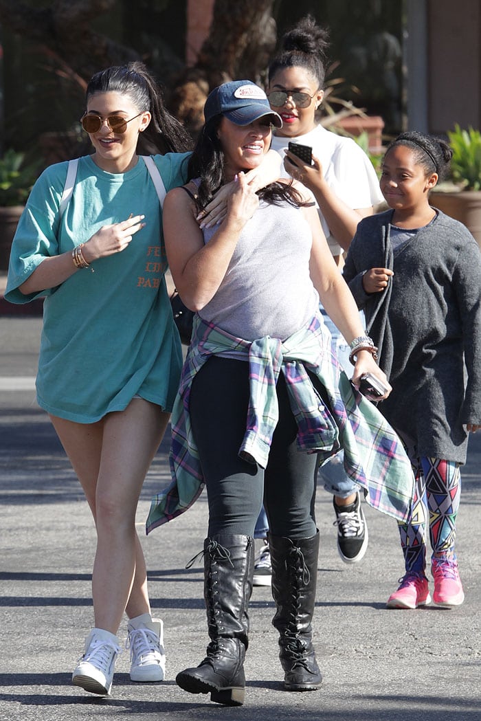 Kylie Jenner wears an oversize blue t-shirt and sneakers as she shops with friends in Malibu