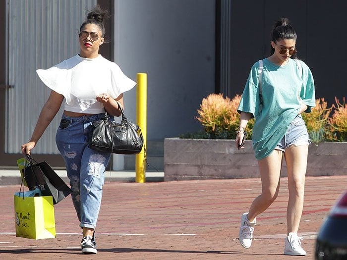 Kylie Jenner shops with friends in an oversized blue t-shirt and denim cut-offs