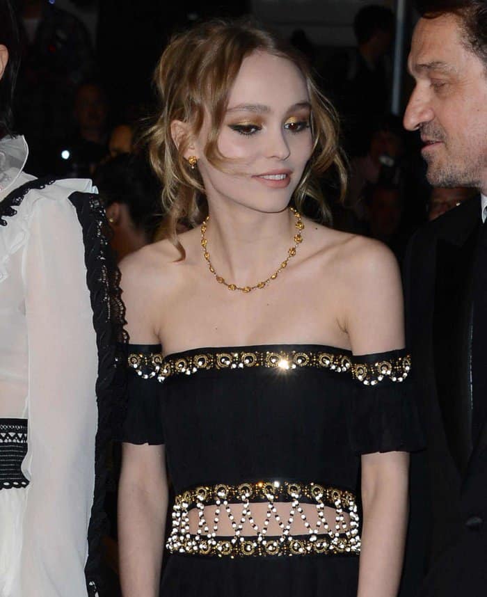 Lily-Rose Depp elegantly flaunted her attire adorned with intricate gold accents