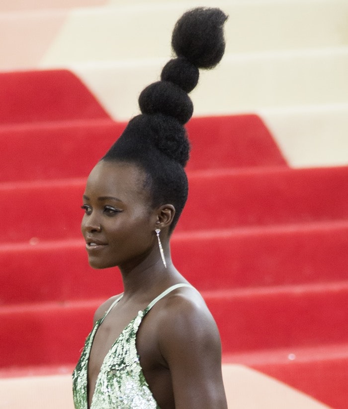 Lupita Nyong’o styles her hair into a towering updo at the 2016 Metropolitan Museum of Art Gala