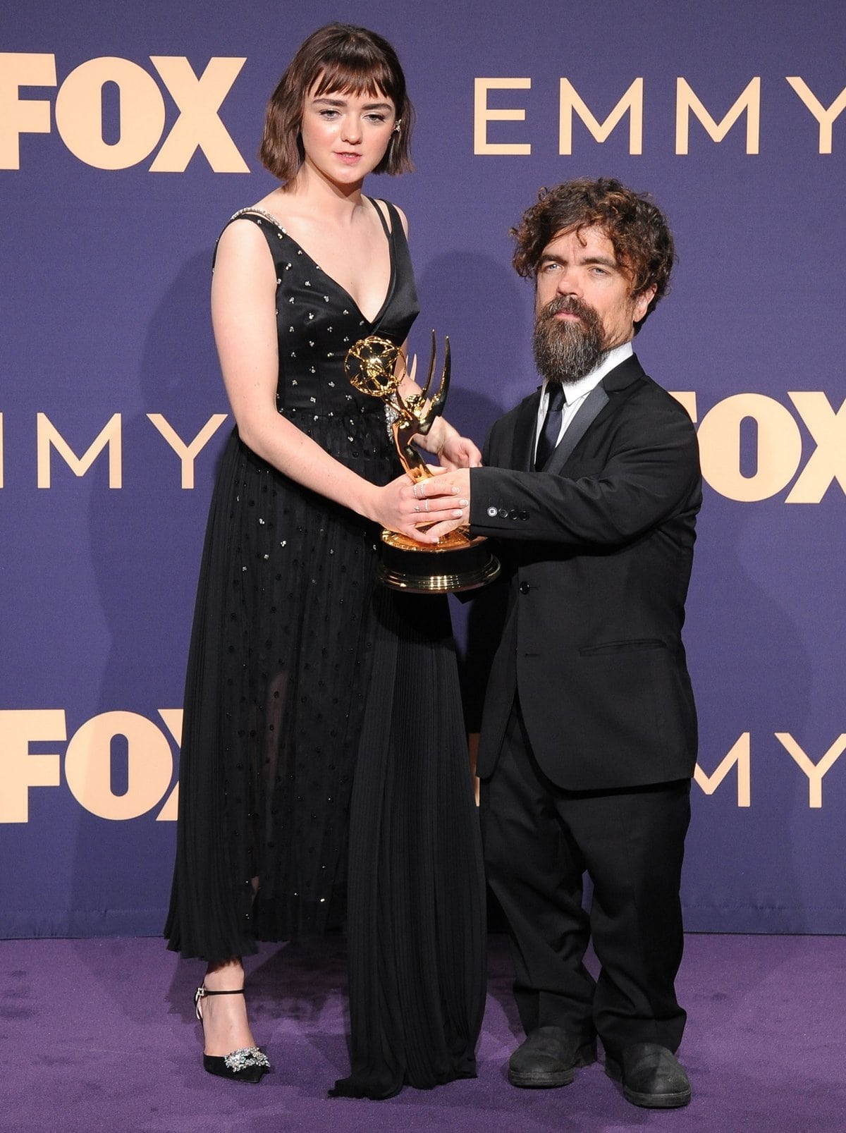 Maisie Williams and Peter Dinklage pose with the award for Outstanding Drama Series