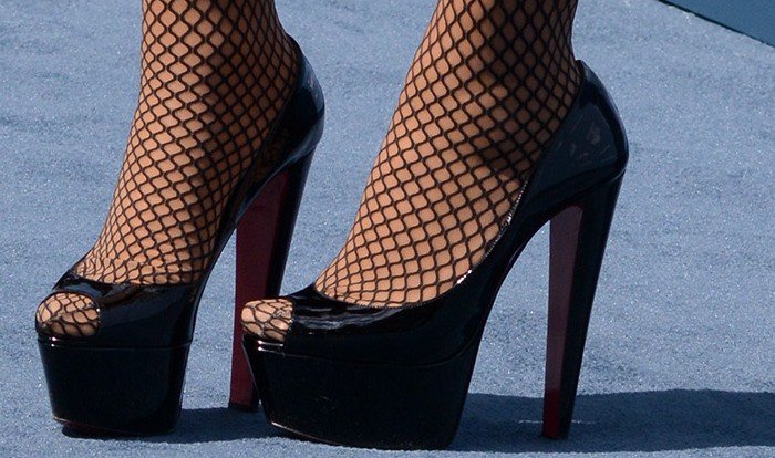 Mariah Carey in fishnet stockings and black Christian Louboutin heels