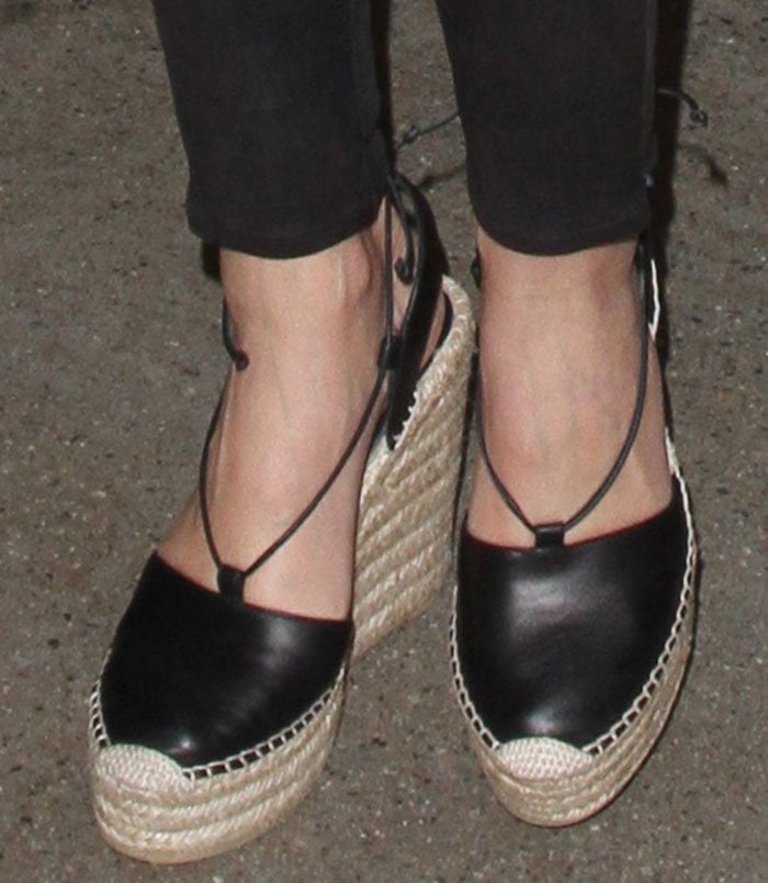 Miranda Kerr's feet in black leather Saint Laurent wedges