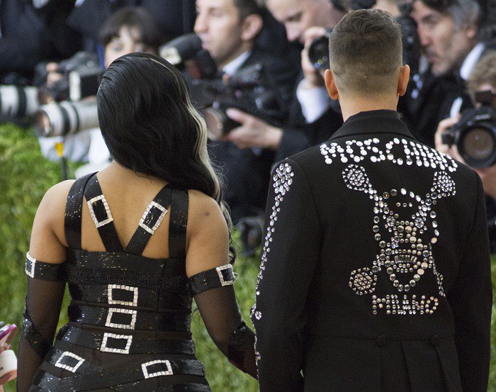 Nicki Minaj's gown featuring rhinestone buckles fastened around her shoulders