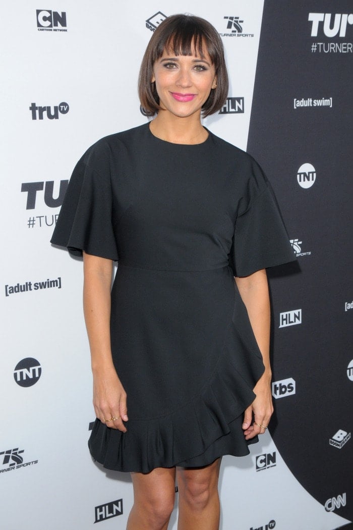 Rashida Jones shows off the ruffled hem and high neckline of her conservative — yet whimsical — black Tibi dress