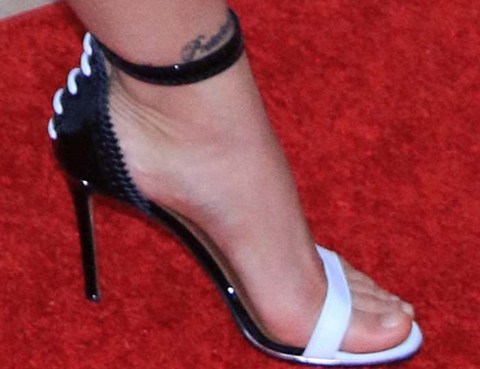 Ronda Rousey's feet and ankle tattoos in black-and-white Givenchy sandals