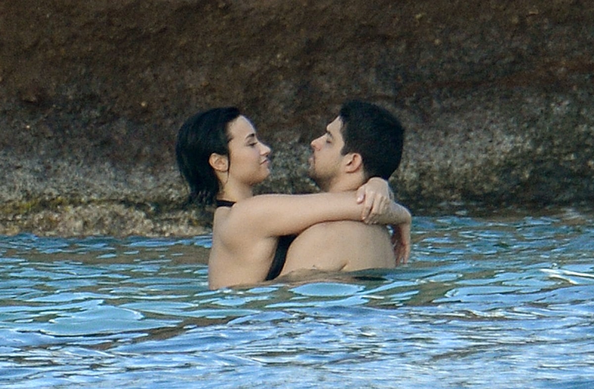 Singer Demi Lovato and boyfriend Wilmer Valderrama seem happy and relaxed as they hug and kiss in the ocean in St. Bart's