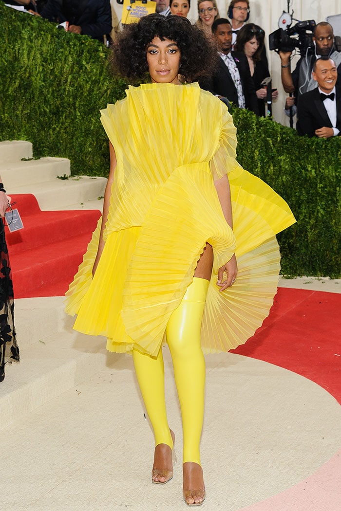 Solange Knowles in a bright yellow fan pleated dress from David LaPort’s Fall 2014 collection
