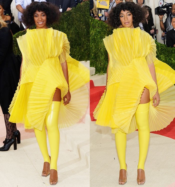 Solange Knowles stuns in a vibrant yellow David LaPort fan-pleated dress featuring dramatic sculptural panels and matching latex thigh-high stirrups