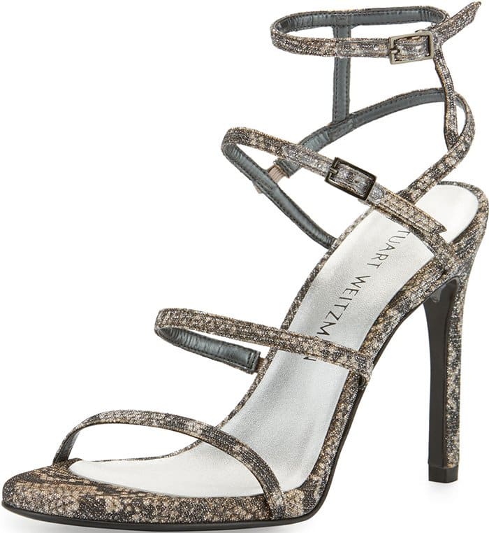 Delicate cage straps curve across a seductive stiletto sandal alight with a shimmering metallic finish