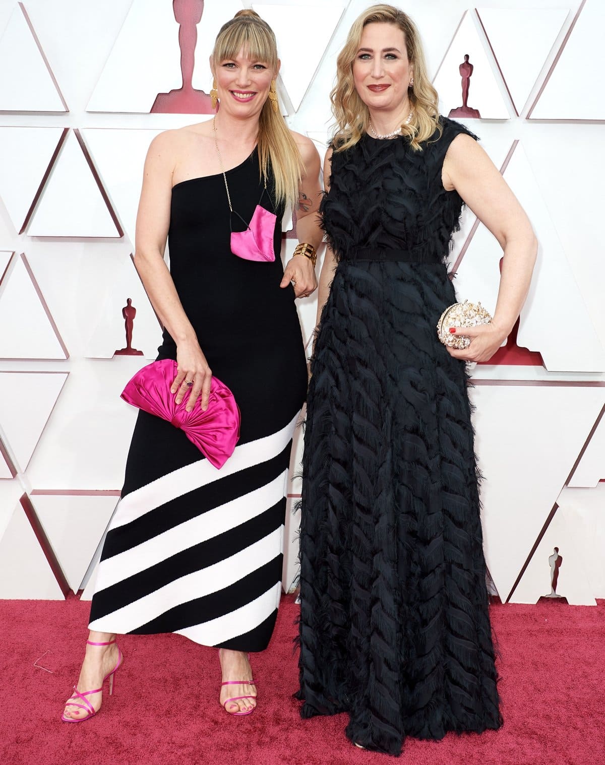 Director Elvira Lind (left) stands out in a bold black-and-white one-shoulder dress with pink accessories, while producer Sofia Sondervan (right) stuns in a textured black gown at the Oscars, where their 2020 short film The Letter Room was nominated for Best Live Action Short Film