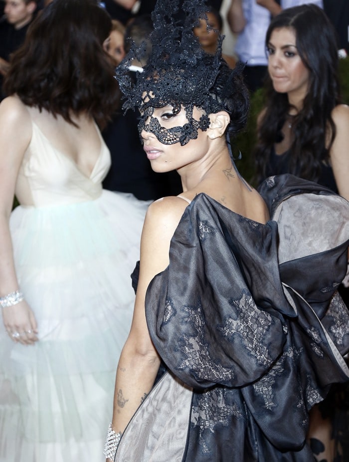 Zoë Isabella Kravitz wears a lace Valentino Fall 2009 Couture Collection mask over her face