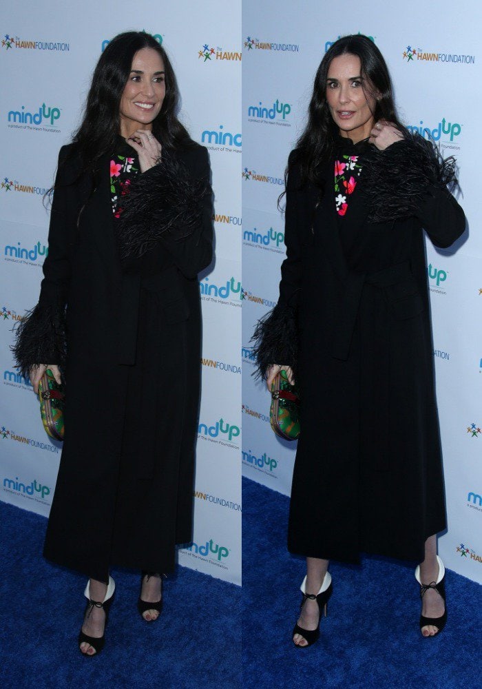 Demi Moore wore a bright floral dress with a long black coat