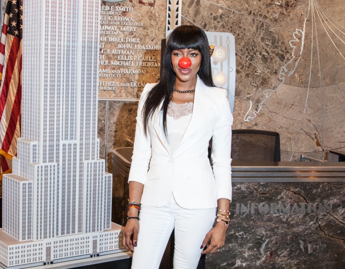 Naomi Campbell styles her red nose with a white Givenchy camisole and a blazer