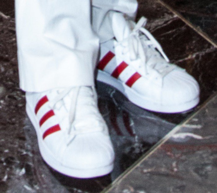 Naomi Campbell wears red-stripe-accented white Adidas sneakers