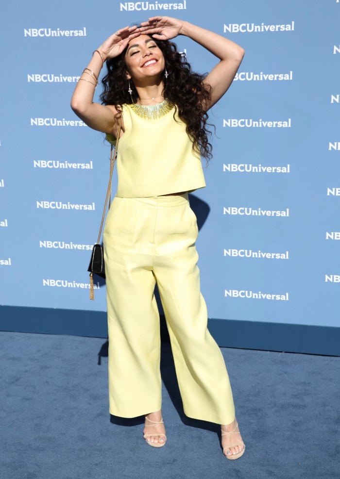 Vanessa Hudgens goofs around on the blue carpet in a pastel yellow Monique Lhuillier set