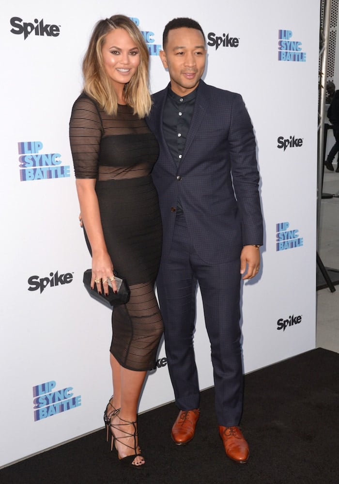 Chrissy Teigen and husband John Legend pose for photos on the "Lip Sync Battle" black carpet