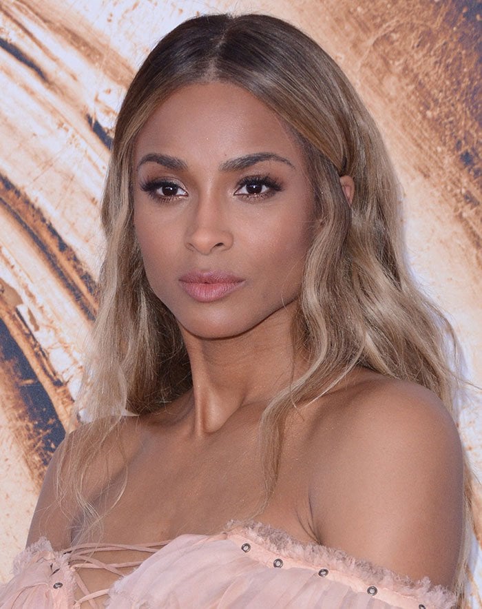 Ciara captivates with soft waves and natural makeup, complementing her elegant blush gown at the CFDA Fashion Awards