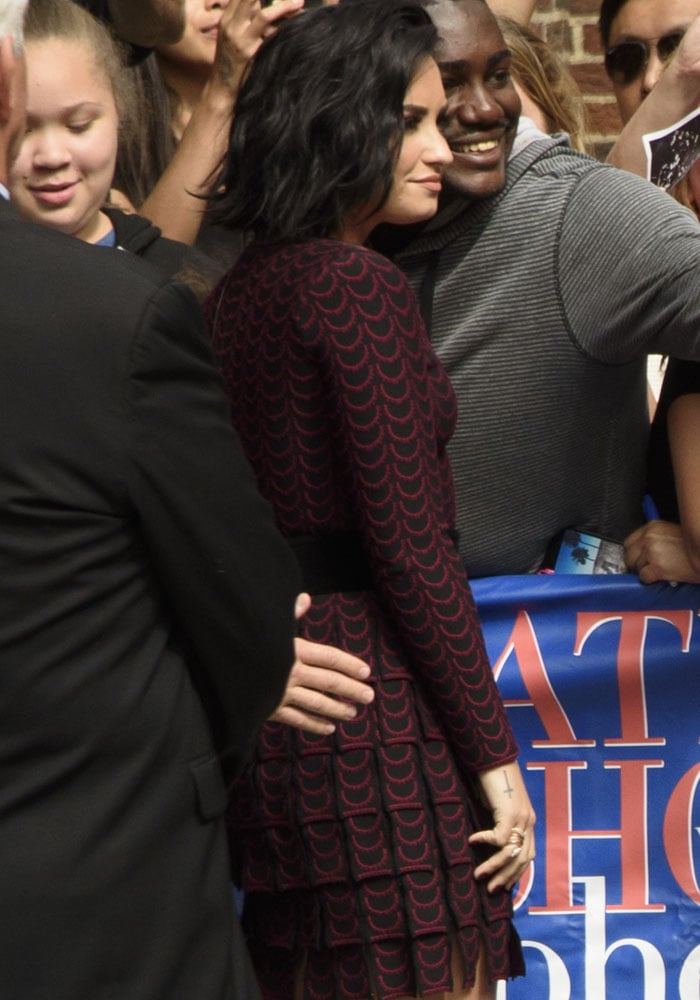 Demi Lovato poses with fans outside of "The Late Night With Stephen Colbert" studios