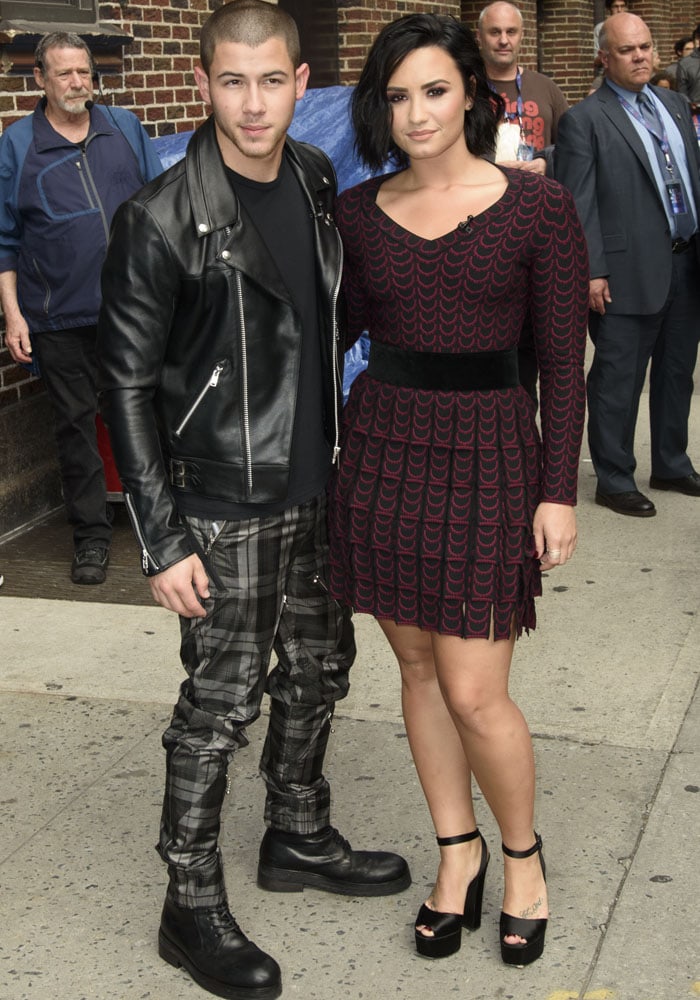 Demi Lovato and Nick Jonas pose for photos outside "The Late Night With Stephen Colbert" studios in New York