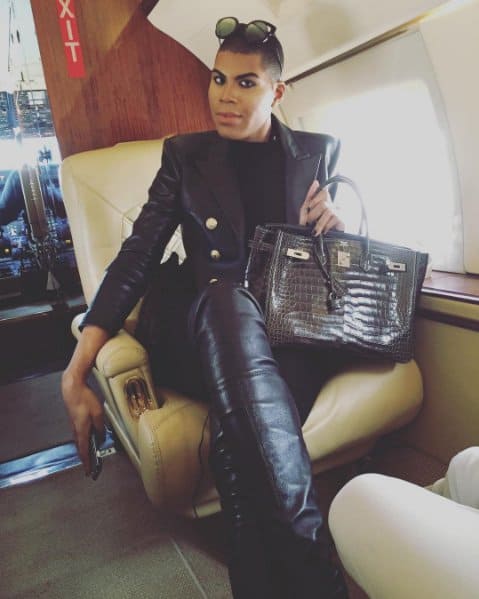EJ Johnson exudes luxury in an all-black leather ensemble paired with a glossy crocodile Hermès Birkin, captured aboard a private jet in this January 2016 Instagram post