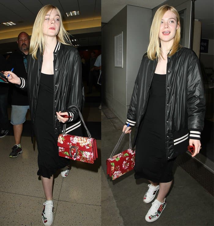 Elle Fanning exuded a vibrant aura as she graced the airport, wrapped in what appeared to be a simple yet chic black slip dress
