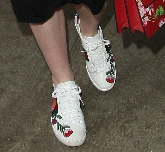 Elle Fanning steps out in style, pairing her chic outfit with eye-catching Gucci "Ace" floral-embroidered sneakers