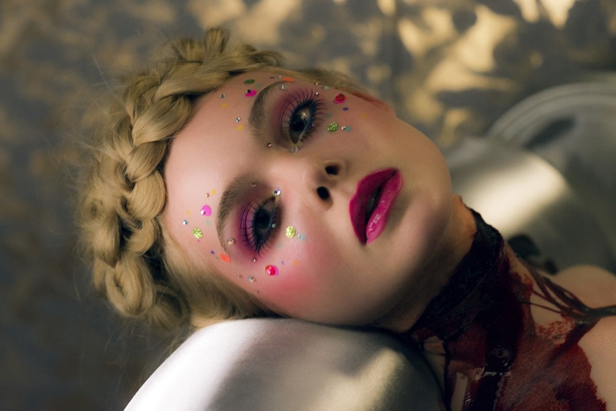In the opening shot of The Neon Demon, Elle Fanning kept her eyes open for so long that her contact lenses were burned onto her eyes by the hot lights
