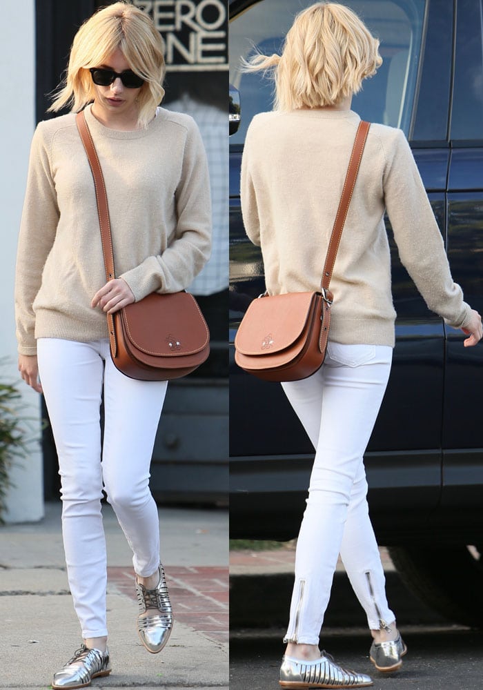 Emma Roberts rocked an AG Adriano Goldschmied Rylea crew sweater and white Rag & Bone zipper trim skinny jeans