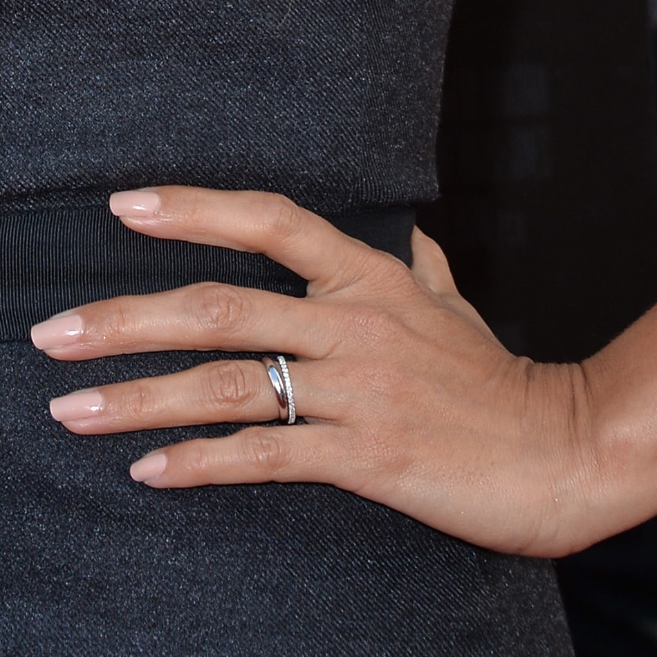 Eva Longoria's thick wedding band provides a bold and solid foundation, while the smaller, diamond-encrusted eternity band adds a touch of sparkle and glamour