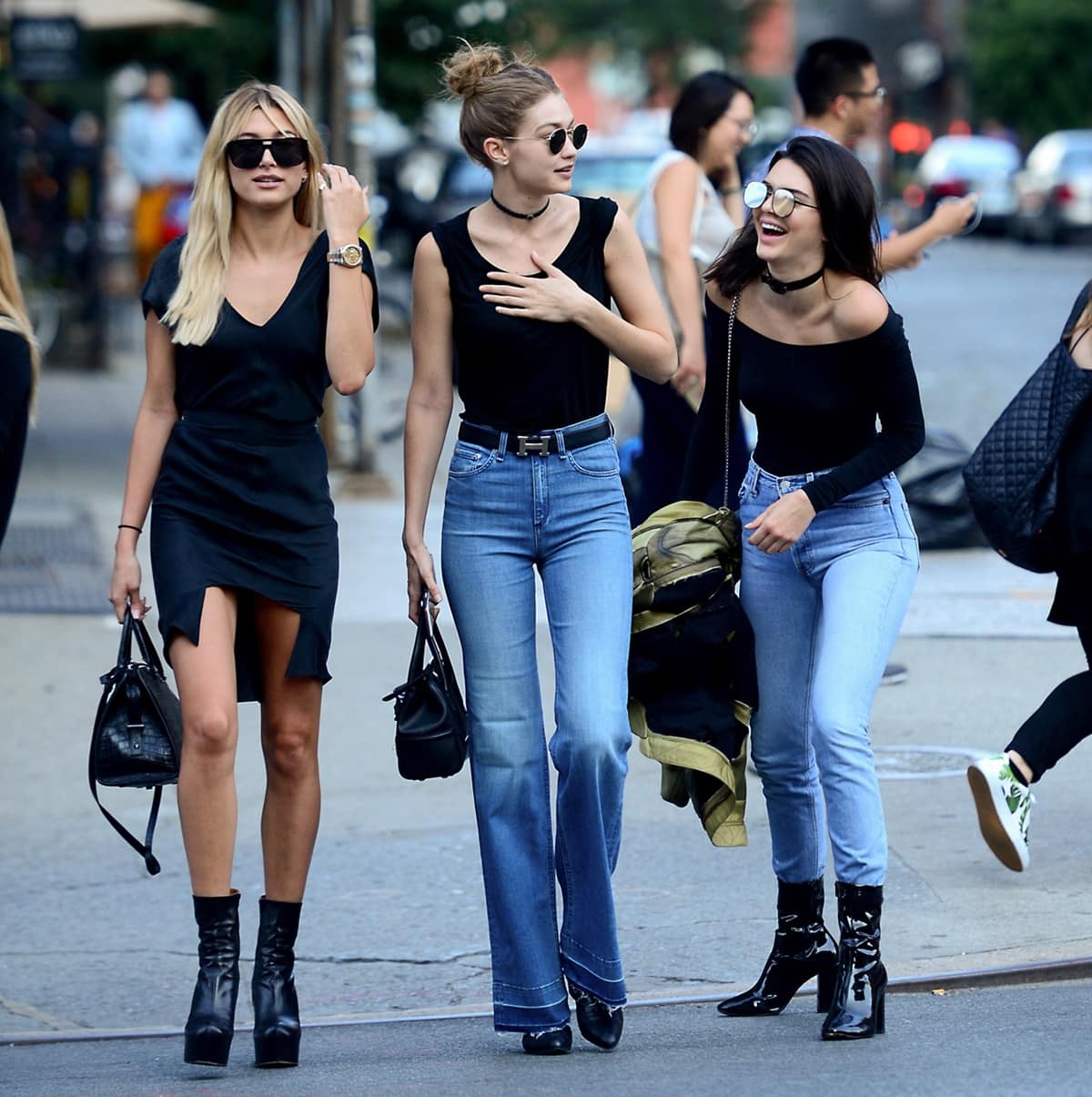 Hailey Baldwin, Gigi Hadid, and Kendall Jenner were seen in coordinated outfits in New York City on Tuesday, with Baldwin opting for a black dress and Vetements boots, Hadid wearing Stuart Weitzman nero soft croco Zepher booties, and Jenner sporting blue jeans, a black top, and black booties