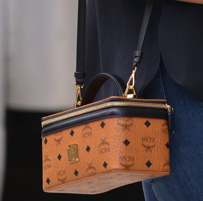 Heidi Klum adds a luxe touch to her outfit with the structured MCM Rockstar vanity case in classic Cognac Visetos leather