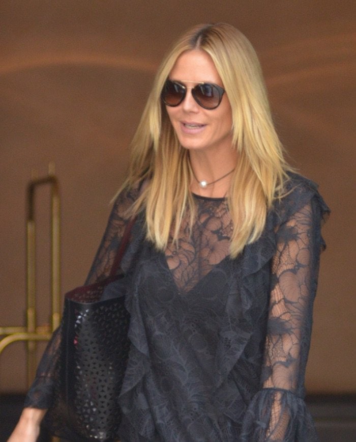 Heidi Klum wears her blonde hair down as she leaves her Manhattan hotel to work on the latest season of "Project Runway"